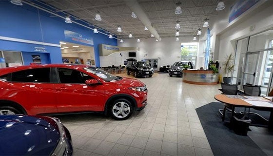 A car dealership featuring a red vehicle prominently displayed in the center.