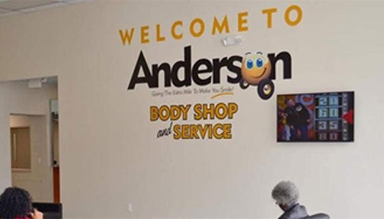 Welcome sign for Anderson Auto Body & Service, featuring the business name prominently displayed.